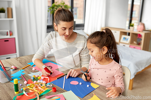 Image of daughter with mother making applique at home