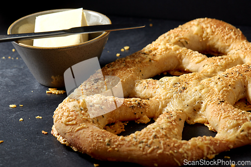 Image of close up of cheese bread, butter and table knife