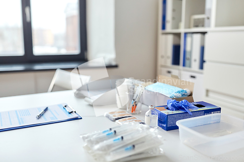 Image of syringes and medicine on table at hospital