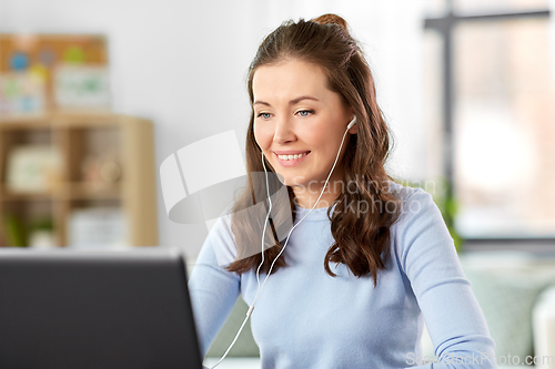 Image of teacher with laptop having online class at home