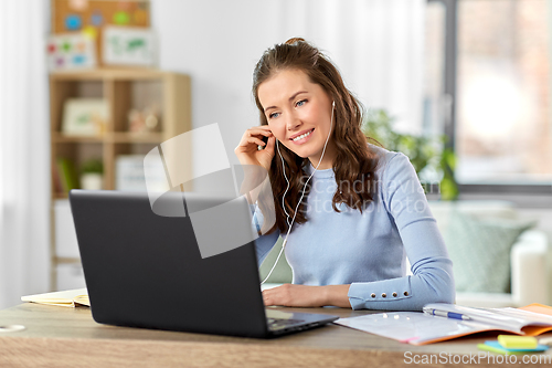 Image of teacher with laptop having online class at home