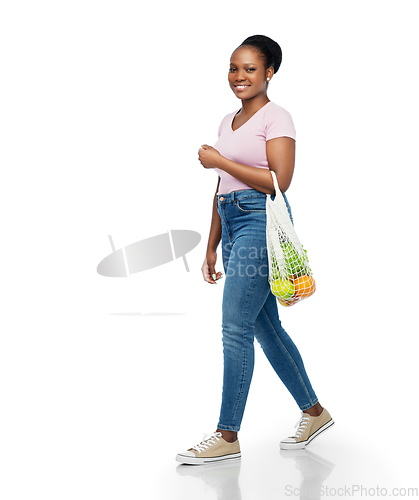 Image of african woman with food in reusable string bag