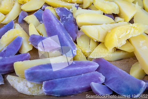 Image of Raw sliced blue and yellow potatoes
