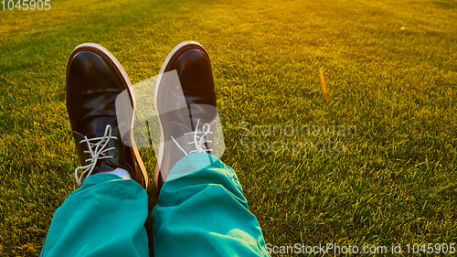 Image of Man relaxing, enjoying landscape on sunny day - point of view