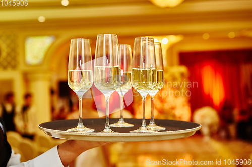 Image of Waiter serving champagne on a tray