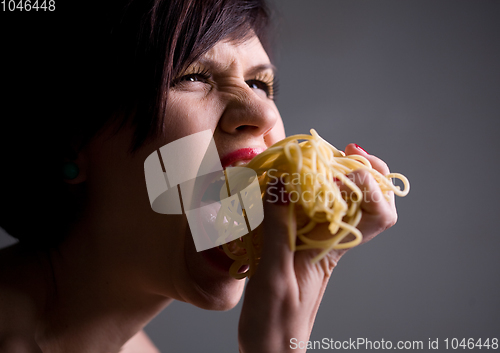 Image of Young person eating tasty noodles