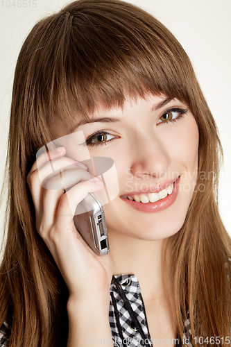 Image of a portrait of attractive young women talking on cellular phone.