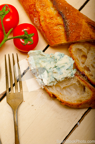 Image of fresh blue cheese spread ove french baguette