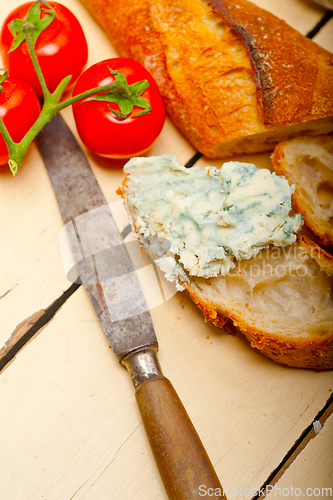 Image of fresh blue cheese spread ove french baguette