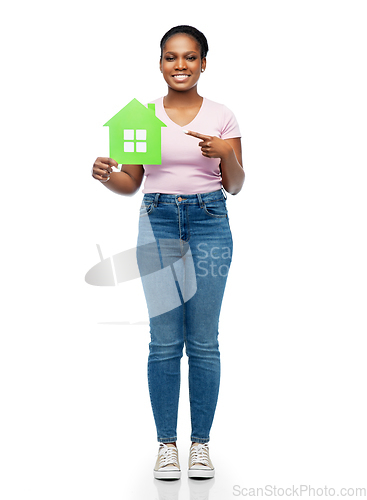 Image of smiling african american woman holding green house