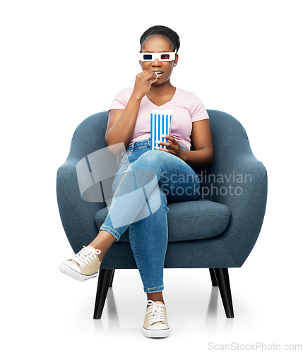 Image of woman in 3d movie glasses eating popcorn in chair