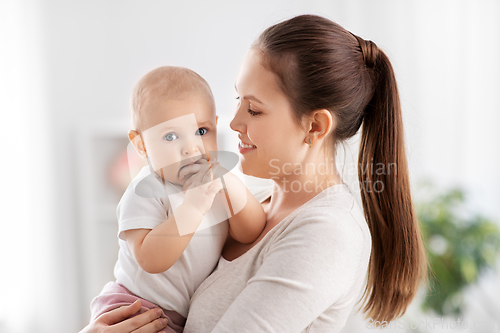 Image of happy mother with little baby daughter at home