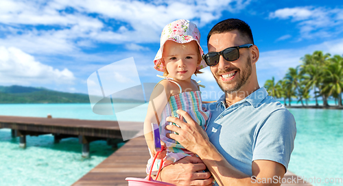 Image of happy father with little daughter on beach