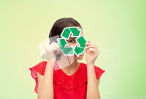 Image of smiling girl holding green recycling sign