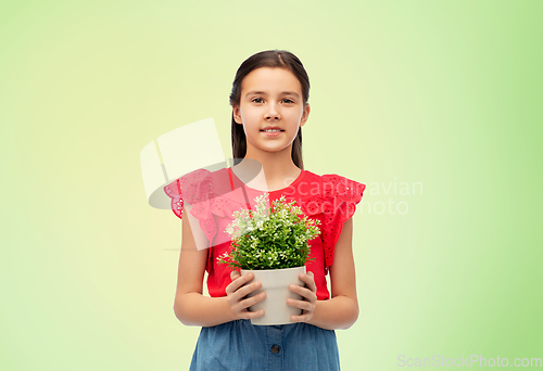 Image of happy smiling girl holding green flower in pot