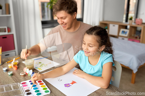 Image of happy father with little daughter drawing at home