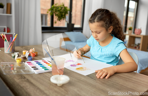 Image of little girl with colors drawing picture at home