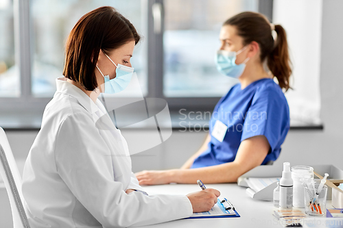 Image of doctor with clipboard and nurse at hospital