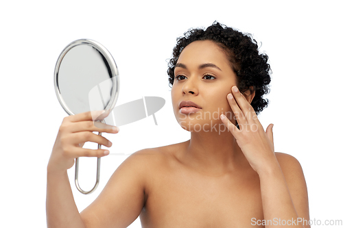 Image of african american woman looking to mirror