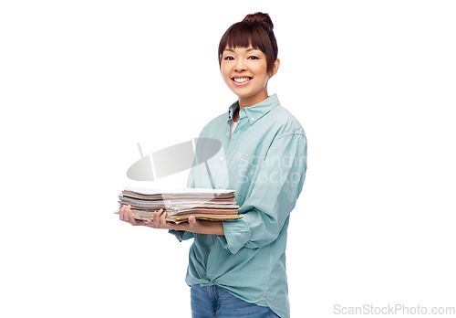 Image of smiling young asian woman sorting paper waste