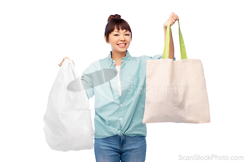 Image of woman comparing reusable tote and plastic bags