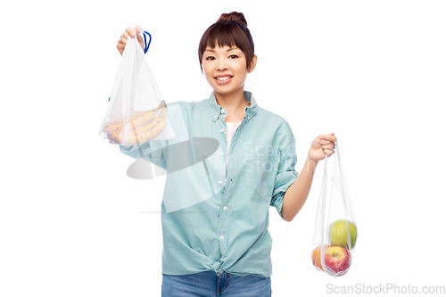 Image of woman with fruits in reusable and plastic bags
