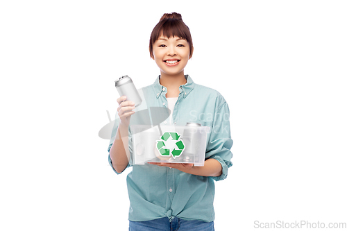 Image of smiling young asian woman sorting metallic waste