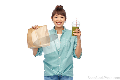 Image of happy asian woman with drink and food in paper bag