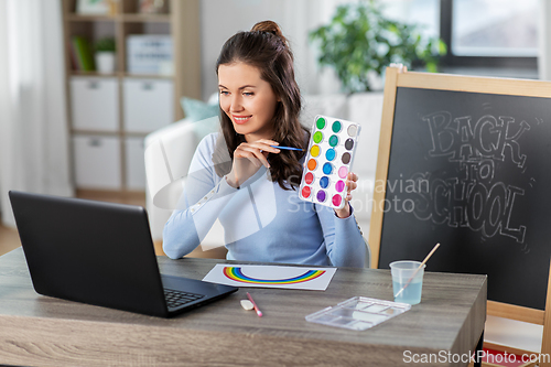 Image of teacher with colors having online class of arts