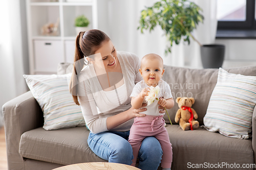 Image of happy smiling mother with little baby at home