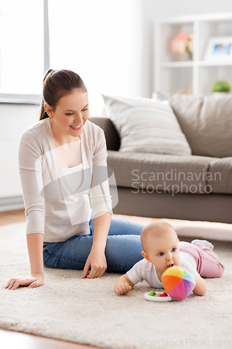 Image of happy smiling mother with little baby at home