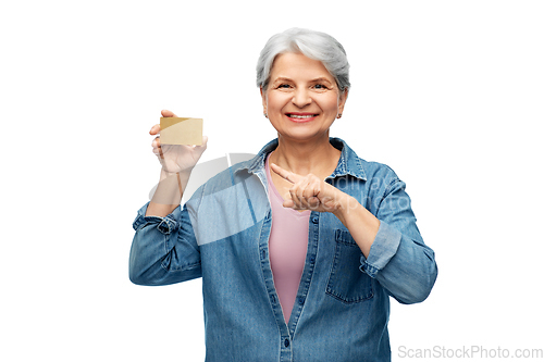 Image of portrait of smiling senior woman with credit card