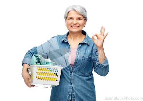 Image of smiling senior woman with laundry basket