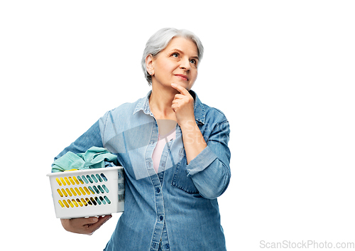 Image of thinking senior woman with laundry basket