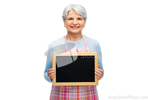 Image of smiling senior woman in apron with chalkboard