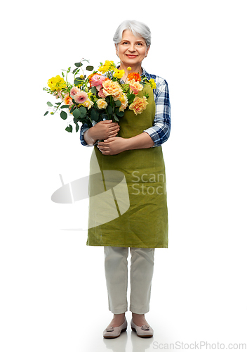 Image of smiling senior woman in garden apron with flowers