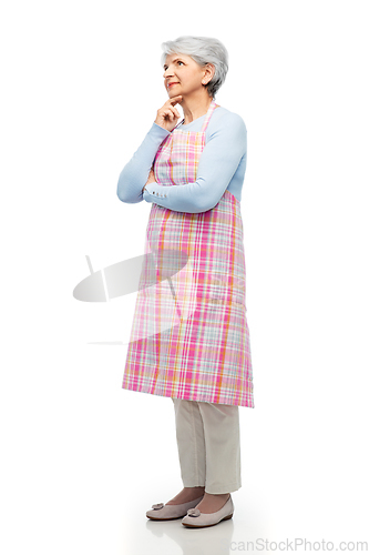 Image of portrait of thinking senior woman in apron