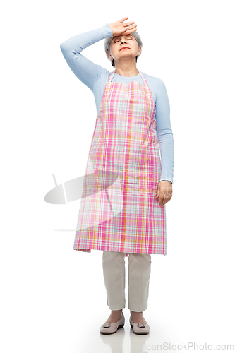 Image of tired senior woman in apron