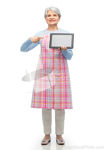 Image of smiling senior woman in apron with tablet computer