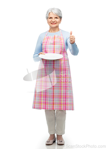 Image of old woman in apron with plate showing thumbs up