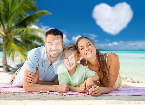 Image of happy family lying over tropical beach background