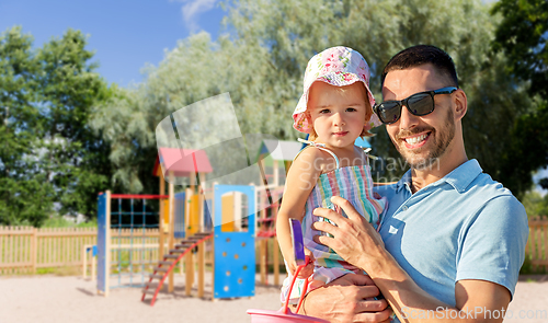 Image of happy father with little daughter on playground