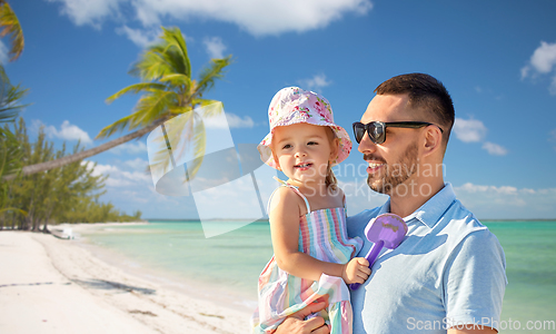 Image of happy father with little daughter on beach