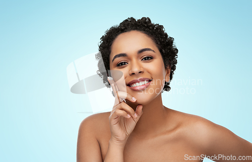 Image of young african american woman with moisturizer