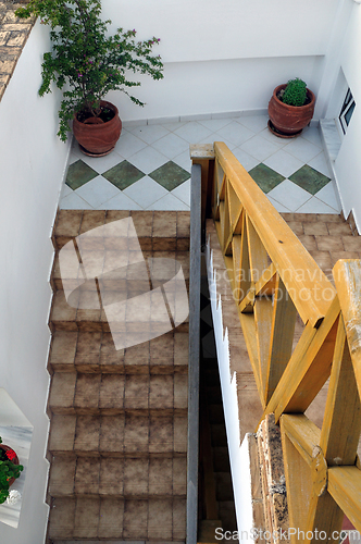 Image of banister and tiled stairway