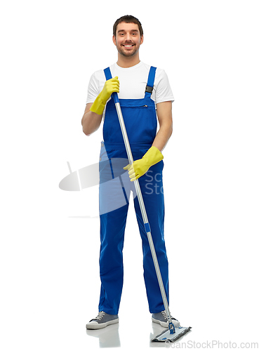 Image of male cleaner in overall cleaning floor with mop