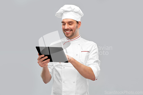 Image of happy smiling male chef with tablet pc computer