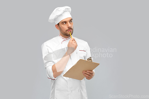 Image of thinking male chef with clipboard