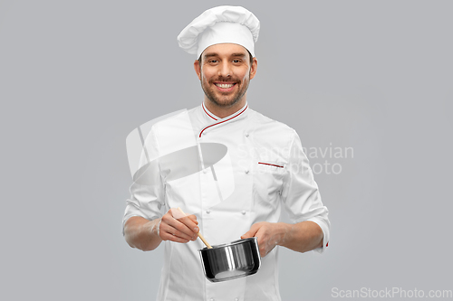 Image of happy smiling male chef with saucepan cooking food