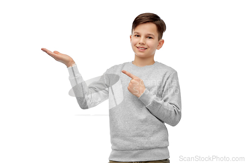 Image of happy boy holding something imaginary on hand